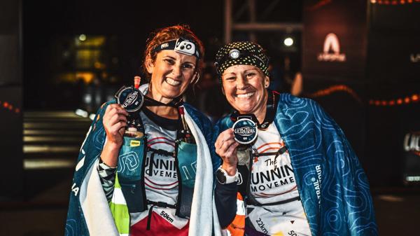 finishers female medals smiles